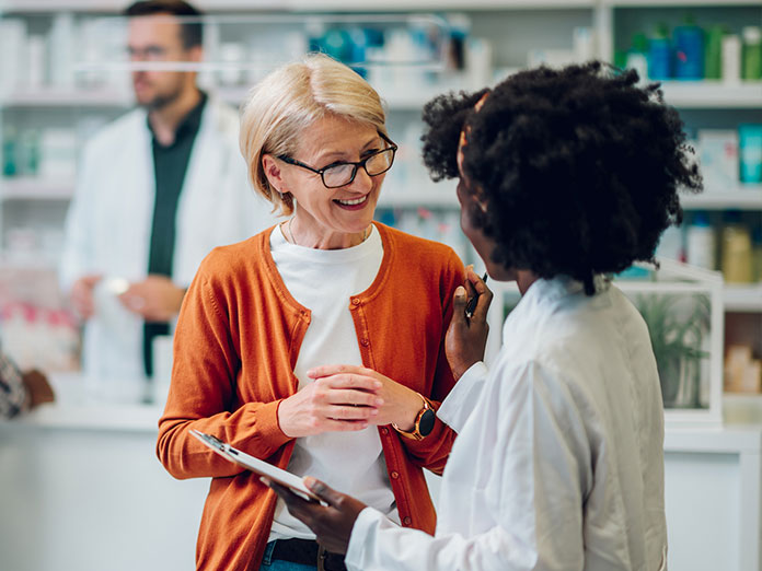 A woman talking with a pharmacist