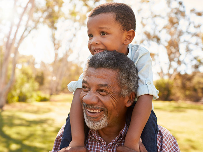 Man holding a child on his shoulder