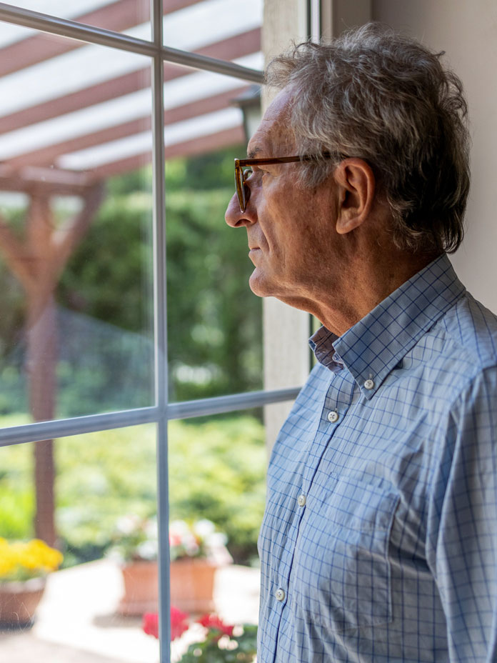 A man looking at the window